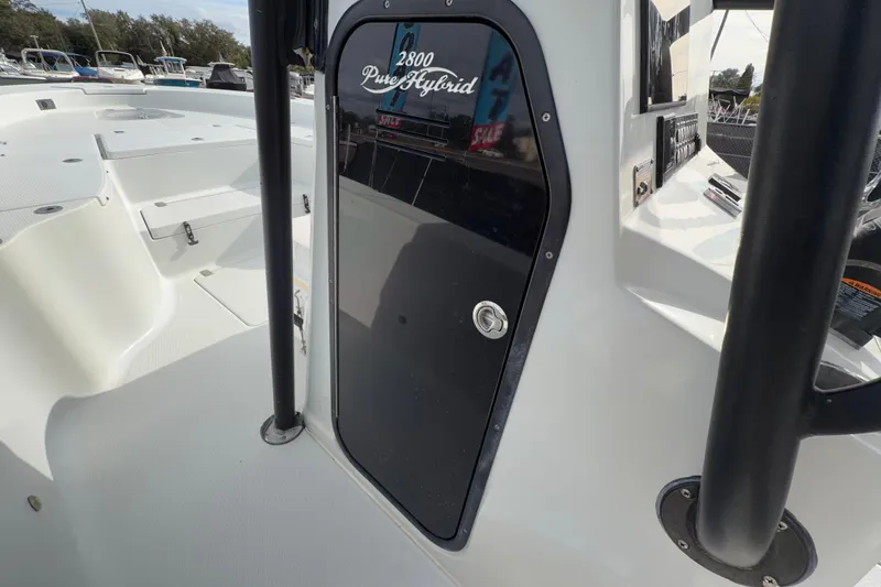 Slide: The Image of Control panel of 2018 Blue Wave 2800 Pure Hybrid boat with keys and pro-trim lever. - 33