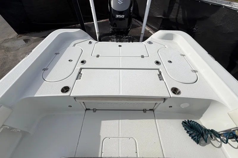 Slide: The Image of 2018 Blue Wave 2800 Pure Hybrid boat deck, featuring seating and storage compartments. - 63
