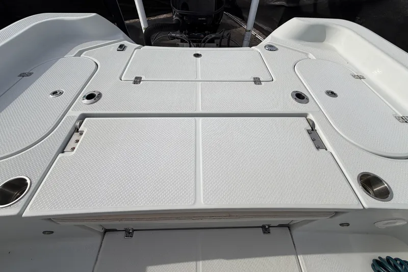 Slide: The Image of 2018 Blue Wave 2800 Pure Hybrid boat interior with cushioned seating and storage compartments. - 65