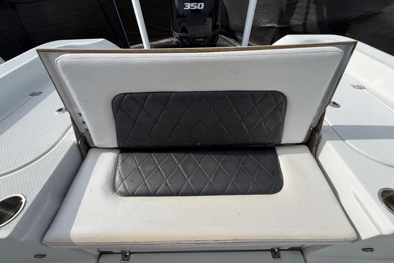 Slide: The Image of 2018 Blue Wave 2800 Pure Hybrid boat interior with seating and console, parked outdoors. - 66