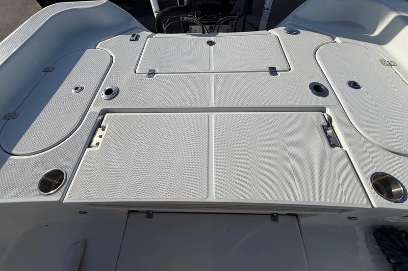 Slide: The Image of 2018 Blue Wave 2800 Pure Hybrid boat deck with storage compartments and cup holders. - 74