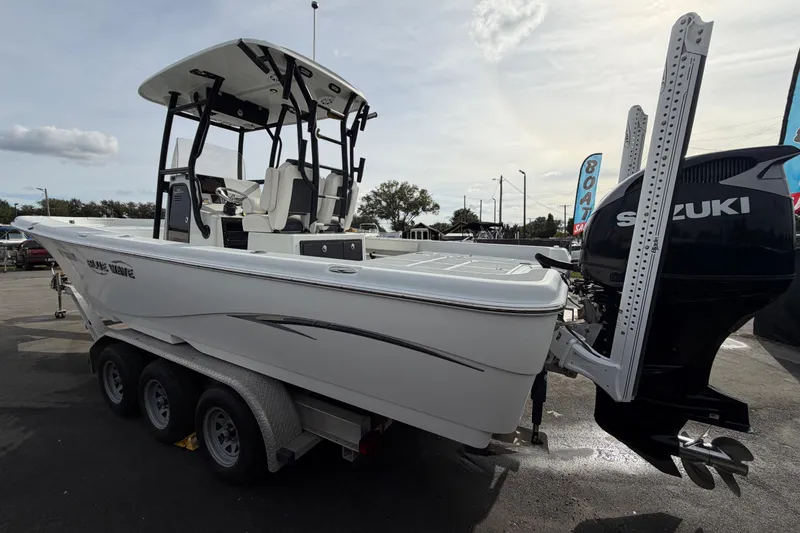 Slide: The Image of 2018 Blue Wave 2800 Pure Hybrid boat on trailer, featuring Suzuki outboard motor. - 8