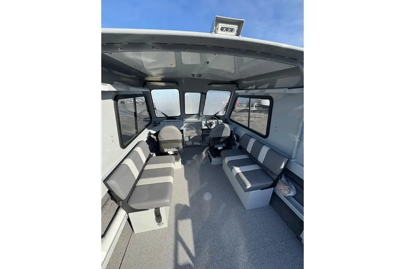 Slide: The Image of 2026 Hewescraft 200 ProV ET HT boat interior with seating and steering wheel. - 4