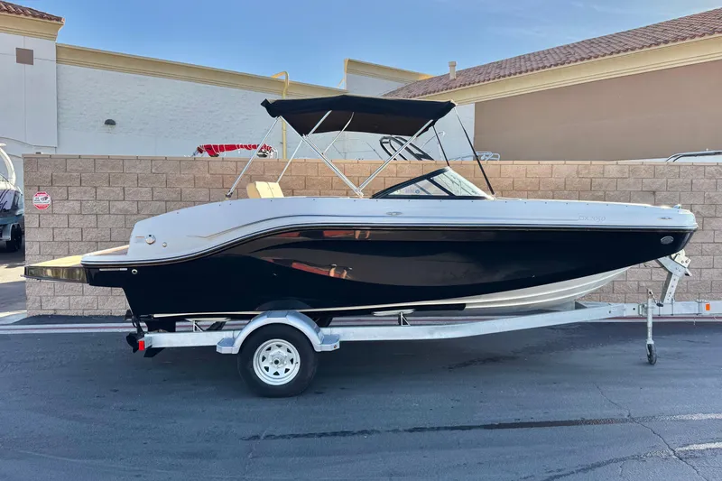 The Image of 2023 Bayliner DX 2050 boat on trailer, parked outdoors. - 0
