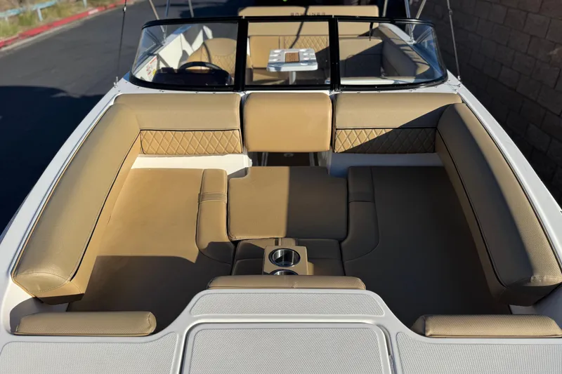 Slide: The Image of 2023 Bayliner DX 2050 boat interior with tan seating and cup holders. - 11