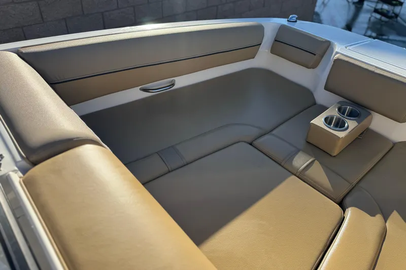 Slide: The Image of 2023 Bayliner DX 2050 boat interior with tan seating and cup holders. - 13