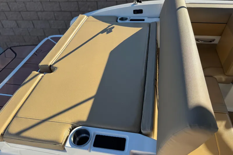 Slide: The Image of 2023 Bayliner DX 2050 boat interior with tan seating and cup holders. - 21