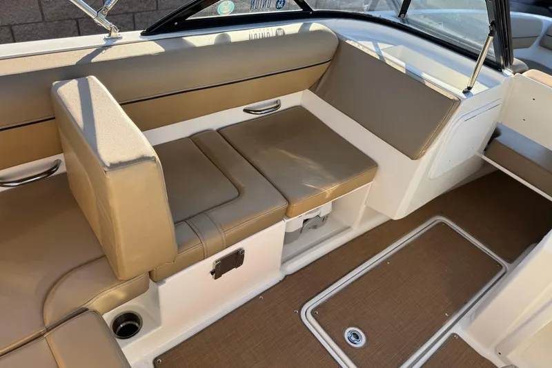 Slide: The Image of 2023 Bayliner DX 2050 boat interior with tan seating and brown flooring. - 23