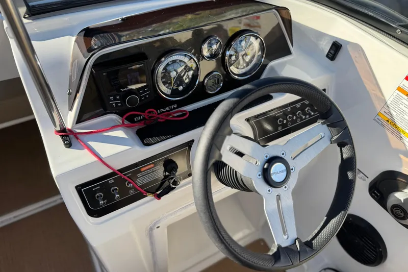Slide: The Image of 2023 Bayliner DX 2050 dashboard with steering wheel and control panel. - 29