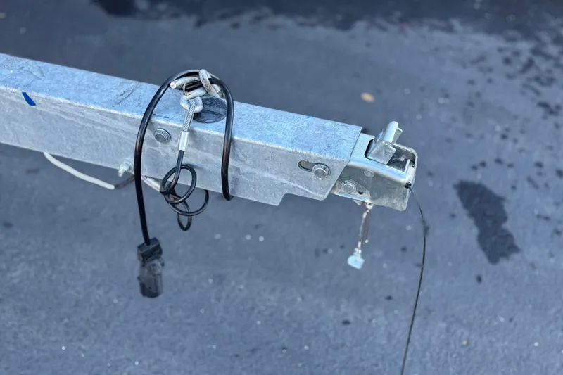 Slide: The Image of Trailer hitch of 2023 Bayliner DX 2050 on asphalt surface. - 31