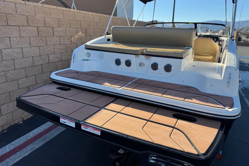 Slide: The Image of 2023 Bayliner DX 2050 boat with spacious rear deck and seating area. - 6