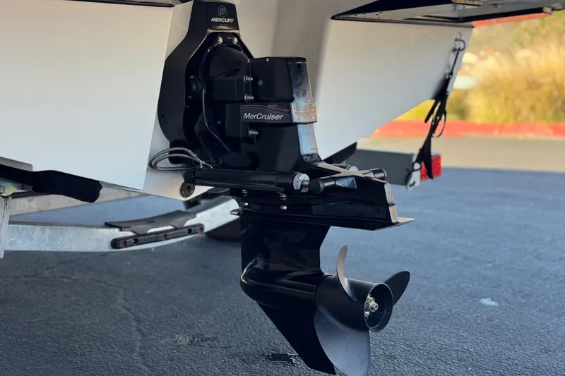 Slide: The Image of 2023 Bayliner DX 2050 boat with MerCruiser engine and propeller, parked on a trailer. - 7