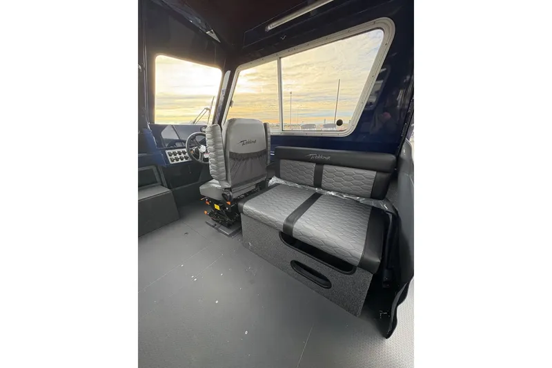 Slide: The Image of Interior of 2026 Weldcraft 210 Revolution HT boat with modern seating and dashboard. - 16