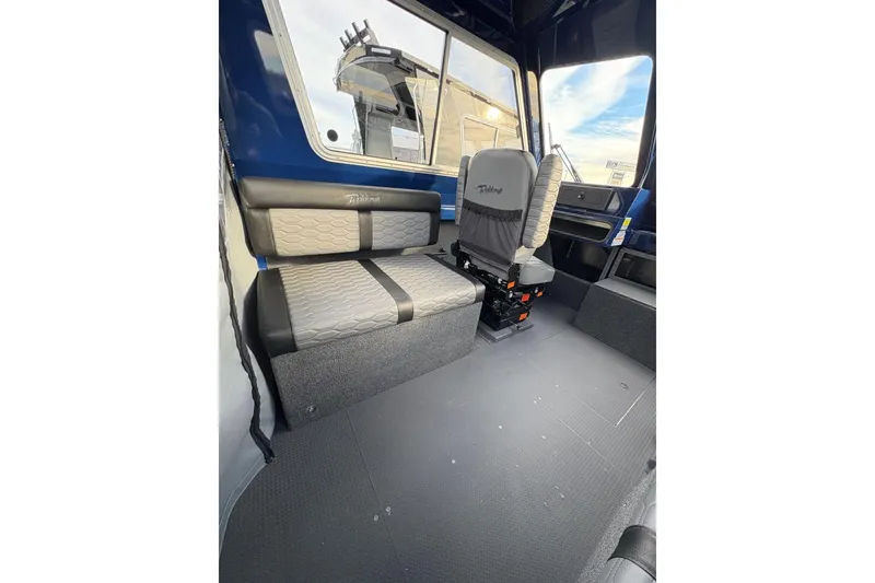 Slide: The Image of Interior of 2026 Weldcraft 210 Revolution HT boat with modern seating and spacious design. - 17