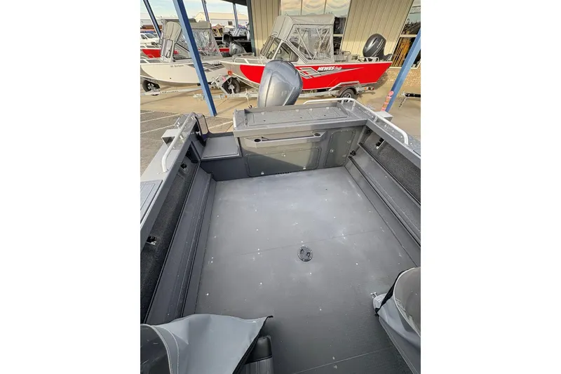 Slide: The Image of 2026 Weldcraft 210 Revolution HT boat interior, spacious deck, and modern design. - 21