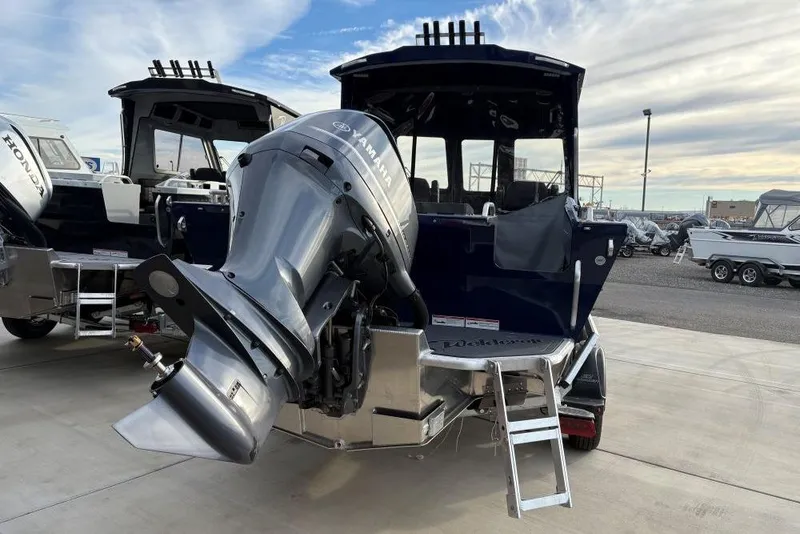 Slide: The Image of 2026 Weldcraft 210 Revolution HT boat with Yamaha outboard motor, docked outdoors. - 14