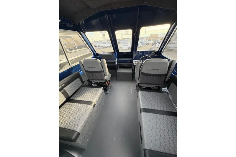 Slide: The Image of Interior of 2026 Weldcraft 210 Revolution HT boat with modern seating and dashboard. - 15