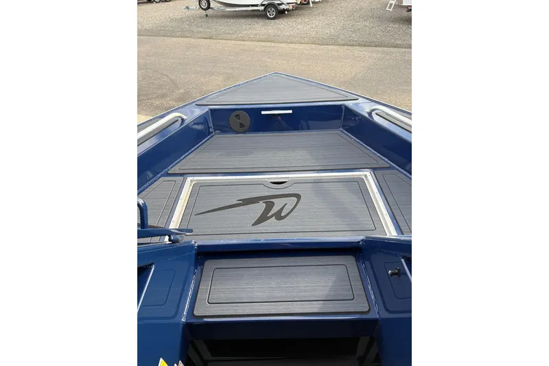 Slide: The Image of 2026 Weldcraft 210 Revolution HT boat deck, featuring sleek blue design and storage compartments. - 20