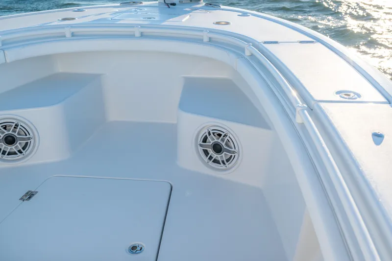 Slide: The Image of 2020 BARKER 26 boat interior with speakers, white seating, and ocean view. - 11