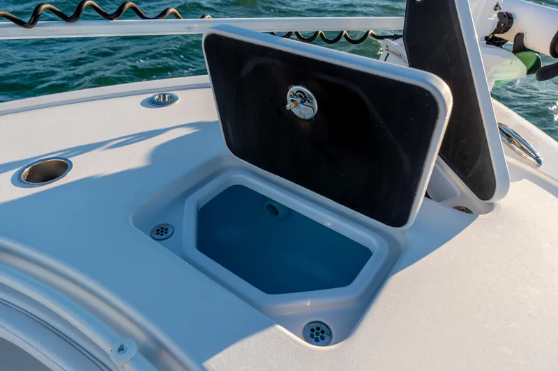 Slide: The Image of Open storage compartment on 2020 BARKER 26 boat, with ocean background. - 13