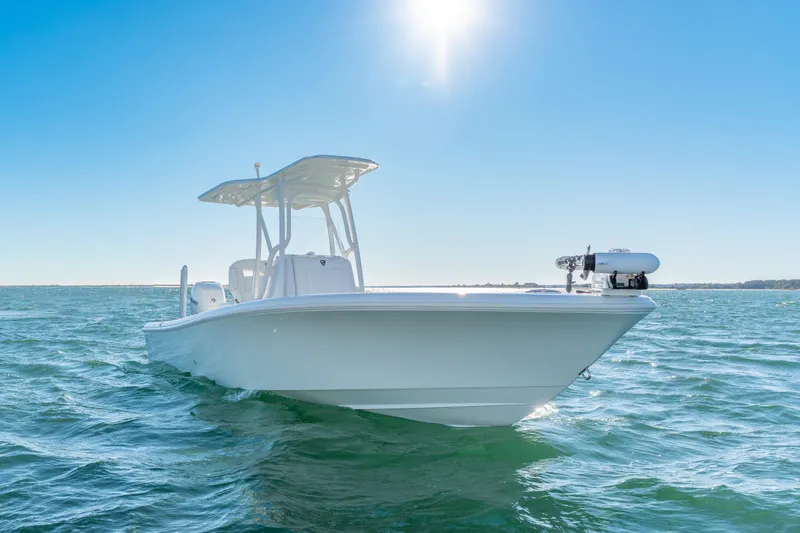 Slide: The Image of 2020 BARKER 26 boat on open water under clear blue sky. - 2