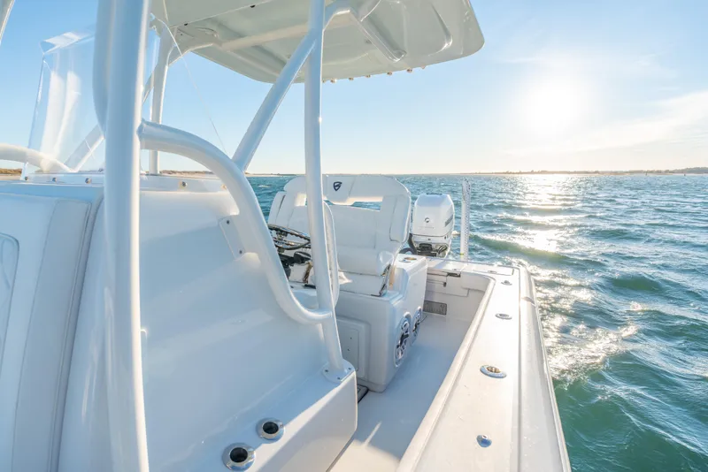 Slide: The Image of 2020 BARKER 26 boat on open water, sunlit deck and calm sea. - 23