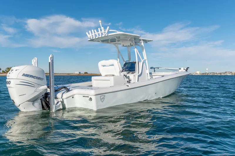 Slide: The Image of 2020 BARKER 26 boat on water with Mercury engine, clear sky background. - 6