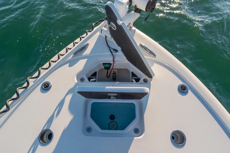 Slide: The Image of Bow of 2020 BARKER 26 boat with open storage compartments on water. - 14