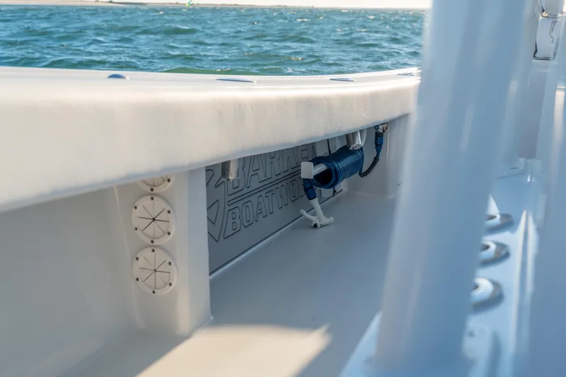 Slide: The Image of Interior view of a 2020 BARKER 26 boat, showcasing deck details and ocean backdrop. - 22