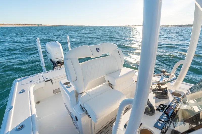Slide: The Image of 2020 BARKER 26 boat interior with white seating and ocean view. - 24