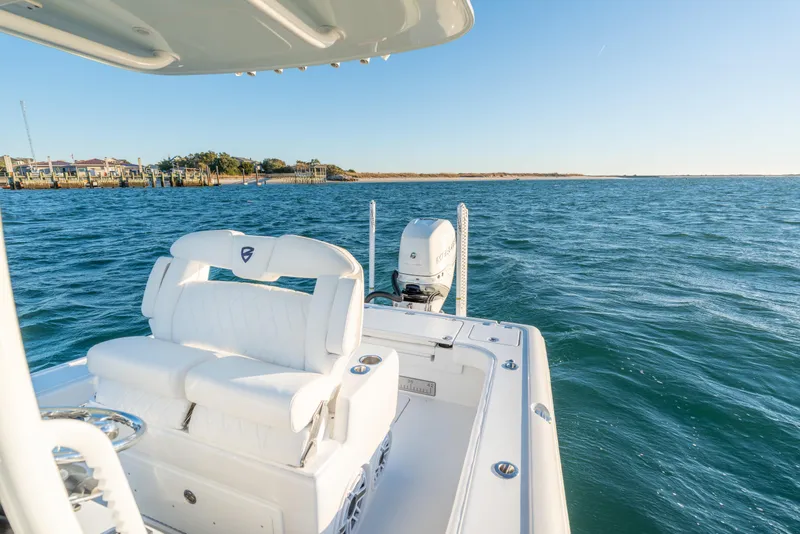 Slide: The Image of 2020 BARKER 26 boat on open water with coastal view. - 25