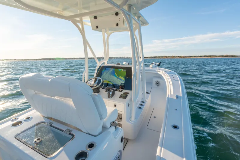 Slide: The Image of 2020 BARKER 26 boat interior with navigation system on open water. - 26