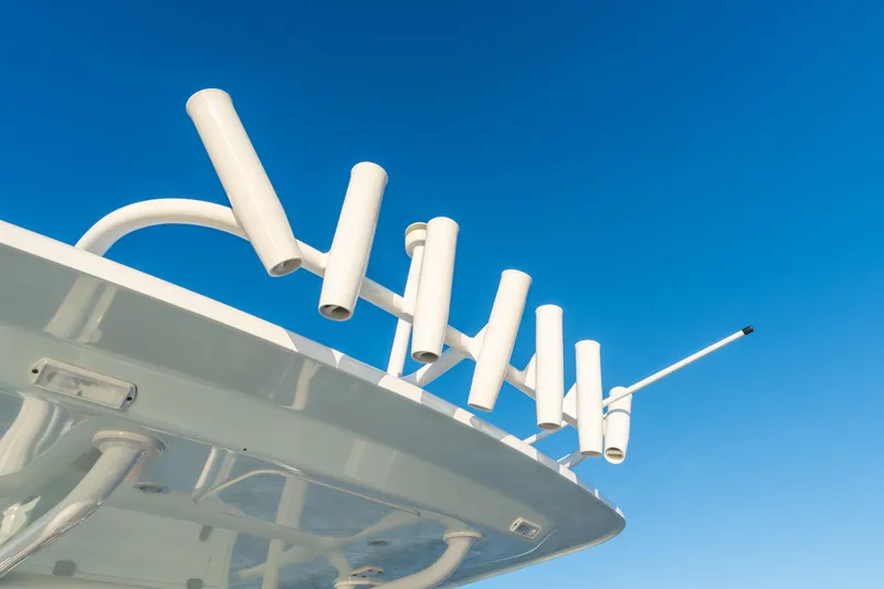 Slide: The Image of Fishing rod holders on a 2020 BARKER 26 boat against a clear blue sky. - 36