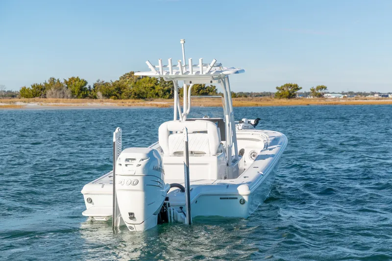 Slide: The Image of 2020 BARKER 26 boat on water, featuring a powerful 400 engine. - 8