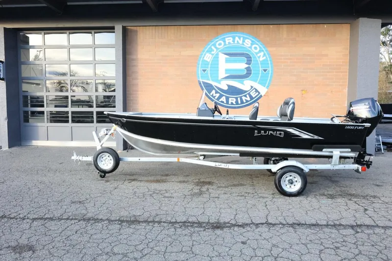 The Image of 2026 Lund 1600 Fury SS boat on trailer at Bjornson Marine dealership. - 1
