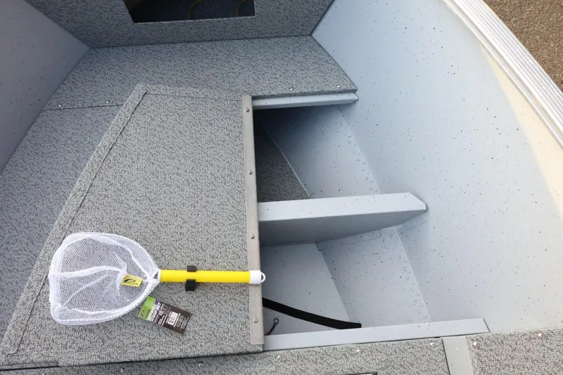 Slide: The Image of Interior of 2026 Lund 1600 Fury SS boat with a fishing net on the deck. - 14