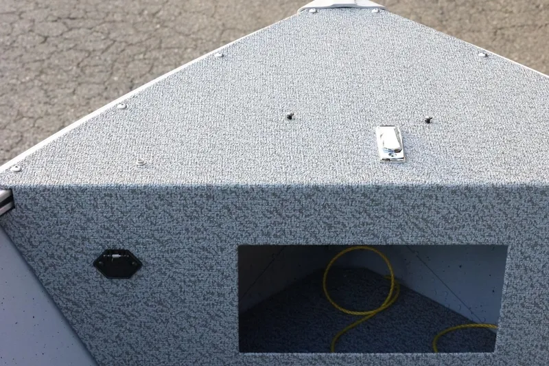 Slide: The Image of 2026 Lund 1600 Fury SS boat deck with textured surface and storage compartment. - 15