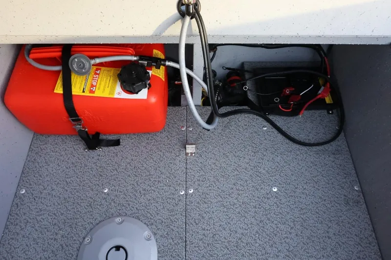 Slide: The Image of 2026 Lund 1600 Fury SS boat interior showing fuel tank and battery compartment. - 20