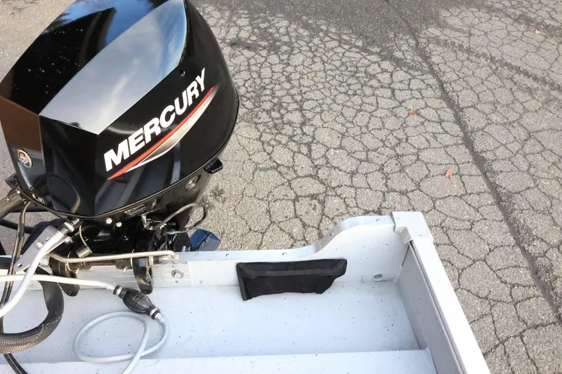 Slide: The Image of 2026 Lund 1600 Fury SS boat with Mercury outboard motor on cracked pavement. - 27