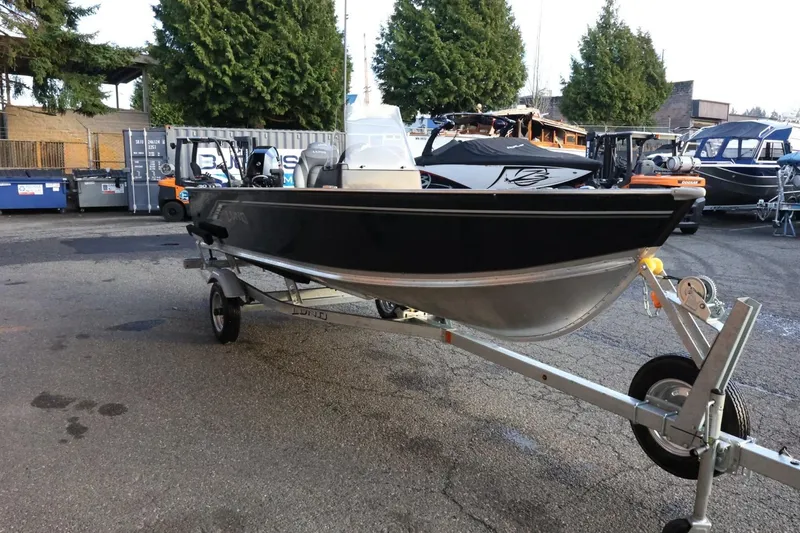 Slide: The Image of 2026 Lund 1600 Fury SS boat on trailer, parked outdoors. - 4