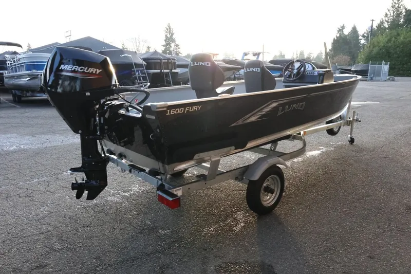 Slide: The Image of 2026 Lund 1600 Fury SS boat with Mercury engine on trailer in parking lot. - 6