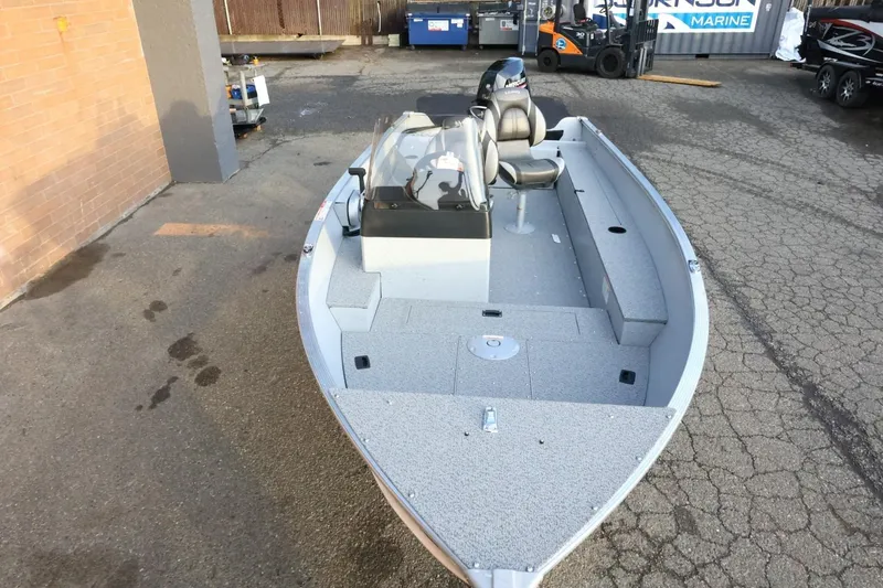 Slide: The Image of 2026 Lund 1600 Fury SS fishing boat in a parking lot, showcasing interior layout. - 8