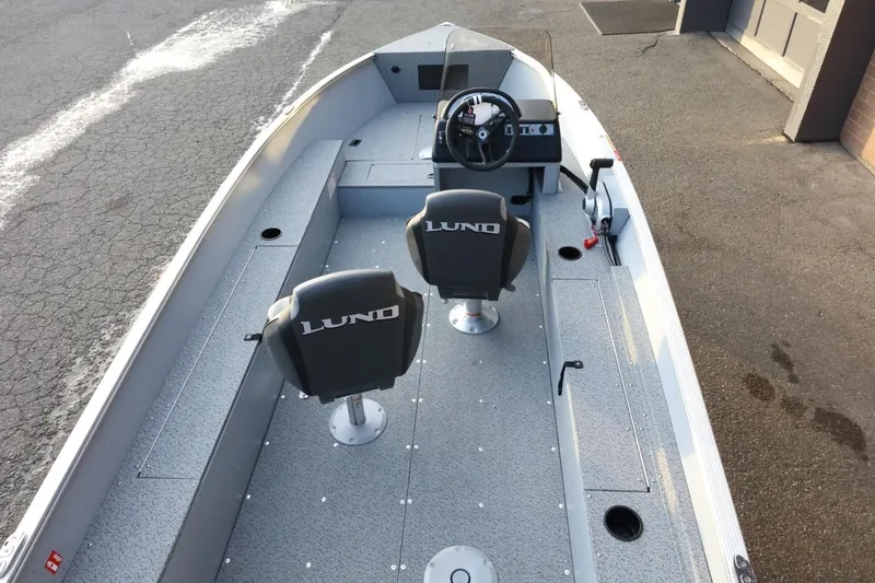 Slide: The Image of 2026 Lund 1600 Fury SS boat interior with two seats and steering console. - 9