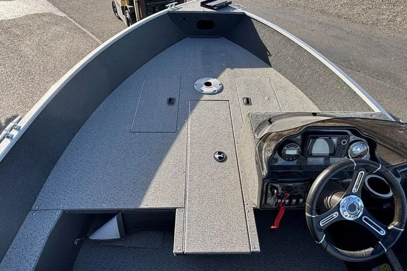 Slide: The Image of 2024 Starweld Fusion Pro 16 SC boat interior with steering console and storage compartments. - 11