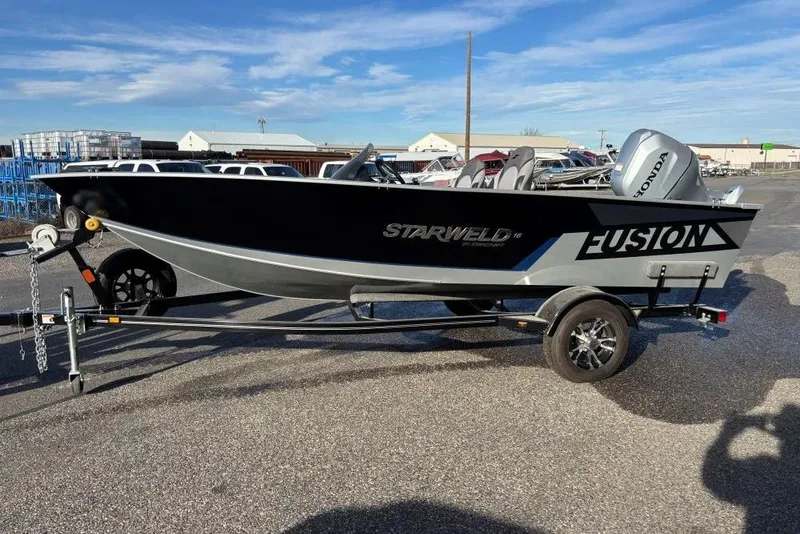 Slide: The Image of 2024 Starweld Fusion Pro 16 SC boat on trailer, featuring Honda outboard motor. - 7