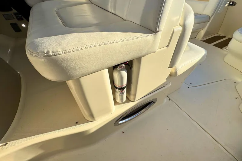 Slide: The Image of 2008 Sea Ray 38 Sundancer interior with white seating and fire extinguisher. - 13