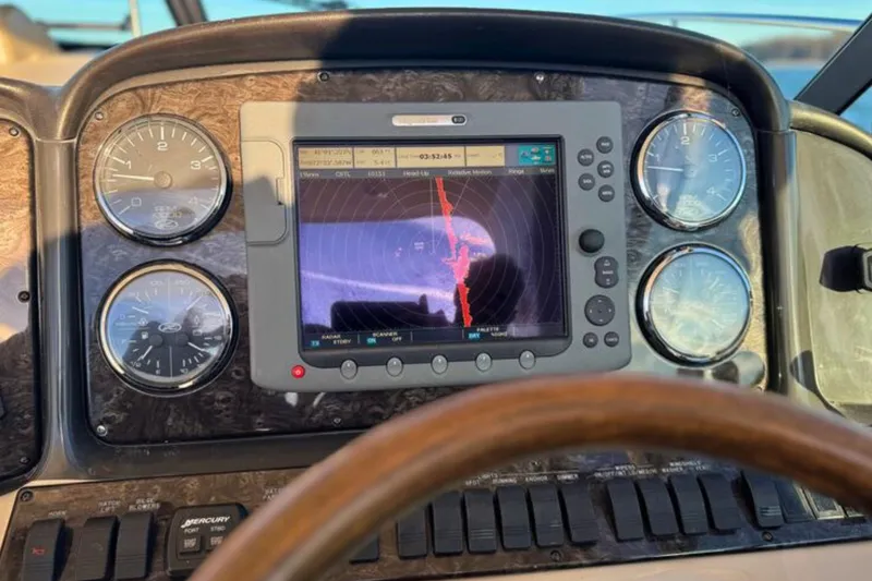 Slide: The Image of Dashboard of 2008 Sea Ray 38 Sundancer with navigation display and gauges. - 17