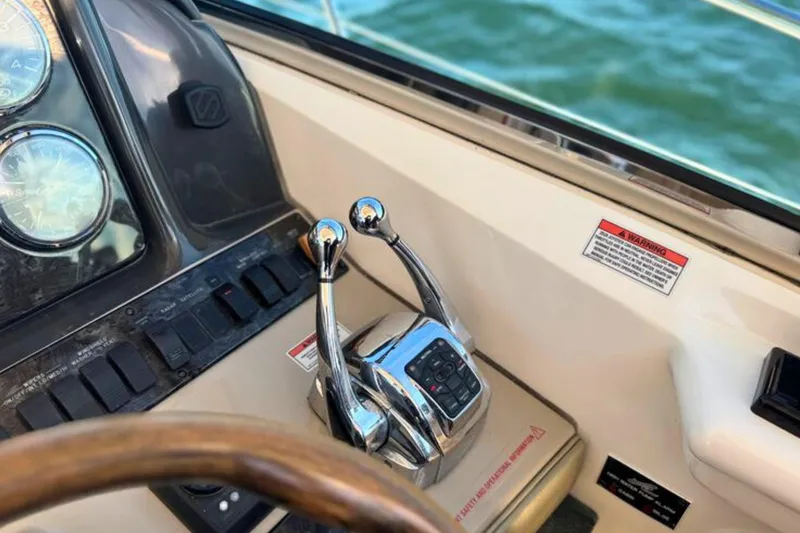 Slide: The Image of Control panel of 2008 Sea Ray 38 Sundancer boat with throttle levers and gauges. - 20