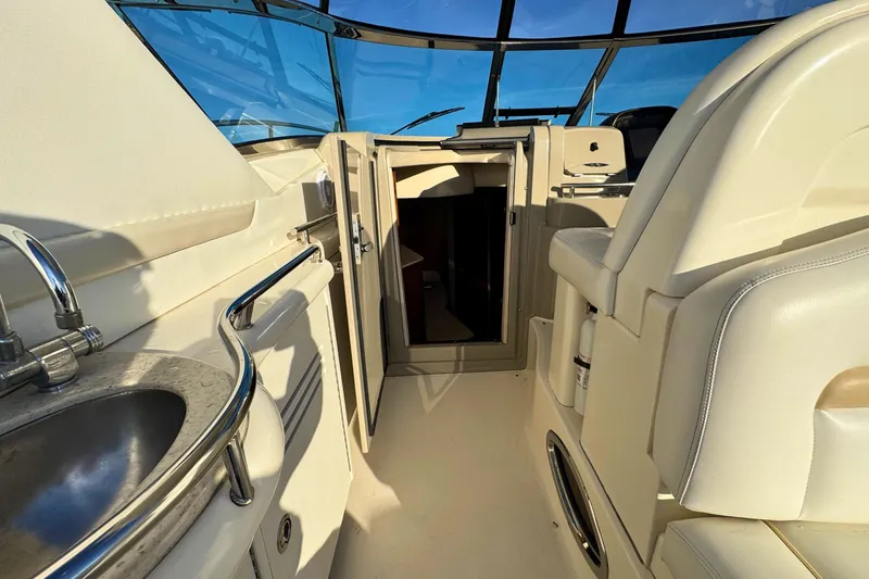 Slide: The Image of 2008 Sea Ray 38 Sundancer yacht interior with helm, sink, and seating. - 24