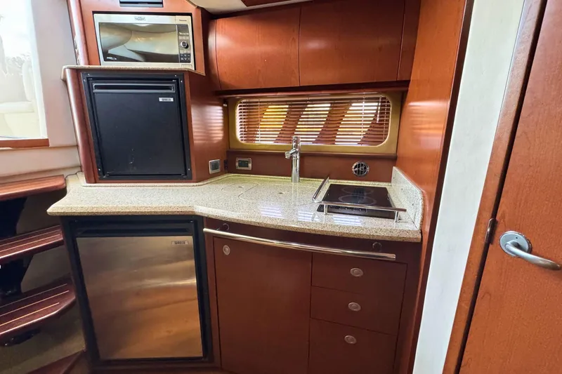 Slide: The Image of Luxurious 2008 Sea Ray 38 Sundancer yacht kitchen with modern appliances and wood cabinetry. - 27